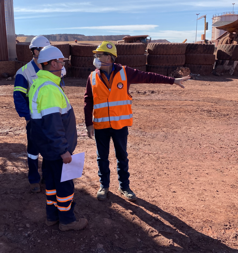 Cbg Men Standing In Desert With Trucks