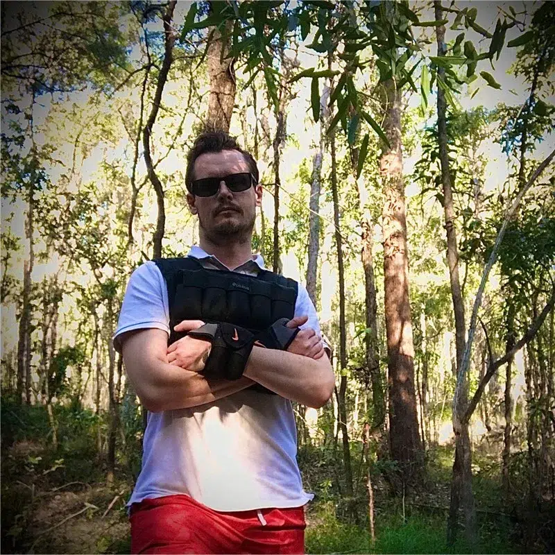 A Man Named Matthew Standing In The Woods With His Arms Crossed