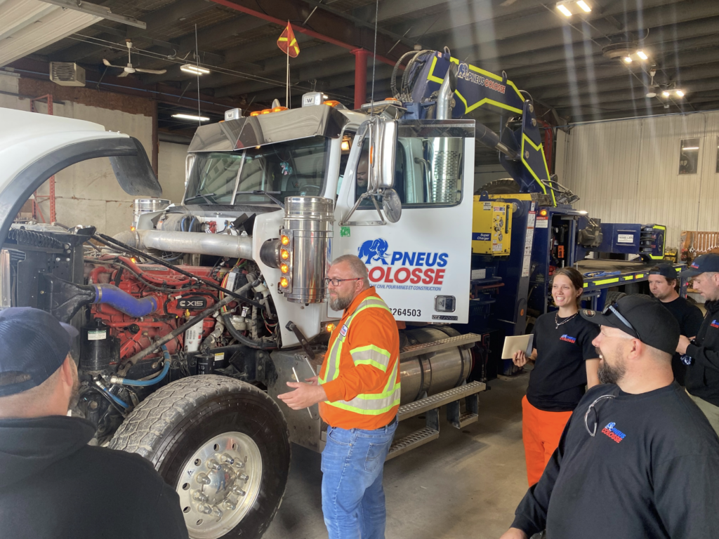 A group of people standing around a truck equipped with Klinge's tire management systems.